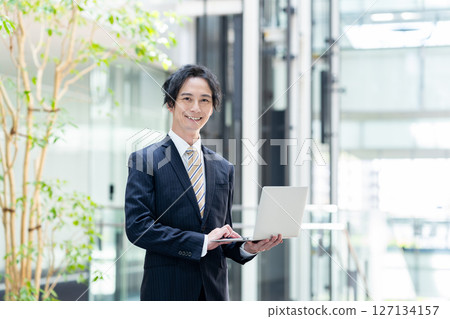 Businessmen working in an office. Filming cooperation: SKY Perfect Tokyo Media Center 127134157