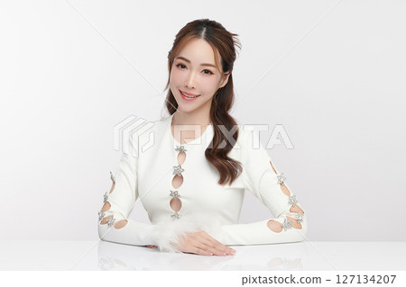 A beautiful young Asian woman with clean, fresh skin against a white background. Skincare, facial treatment, cosmetology, beauty, and spa. An elegant portrait of an Asian woman. A beautiful young Asian woman with clean, fresh skin against a white background. Skincare, facial treatment, cosmetology, beauty, and spa. An elegant portrait of an Asian woman. 127134207