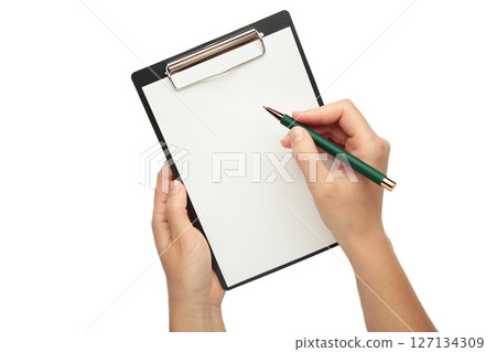 A female hand hold a pen and black clipboard with paper isolated white background. A female hand hold a pen and black clipboard with paper isolated white background. 127134309