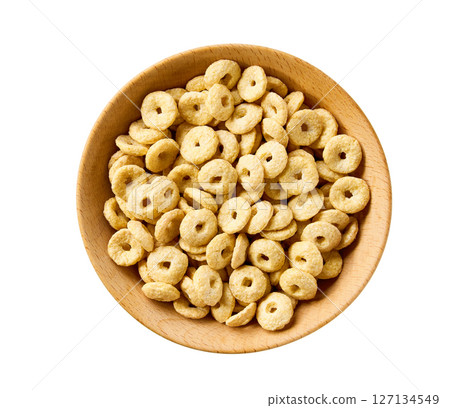 wooden bowl of whole grain cereal rings isolated on a white background, top view. 127134549