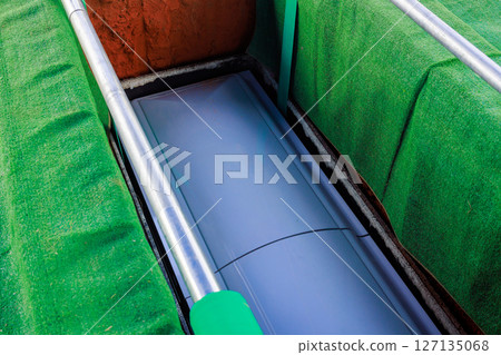 During burial, casket falls into the ground during ceremony in a serene cemetery setting 127135068