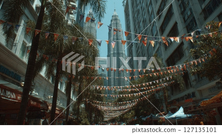 Kuala Lumpur towers framed by bunting. A lively street with people, blending modern architecture and festive culture in the Malaysian city Kuala Lumpur towers framed by bunting. A lively street with people, blending modern architecture and festive culture in the Malaysian city 127135101