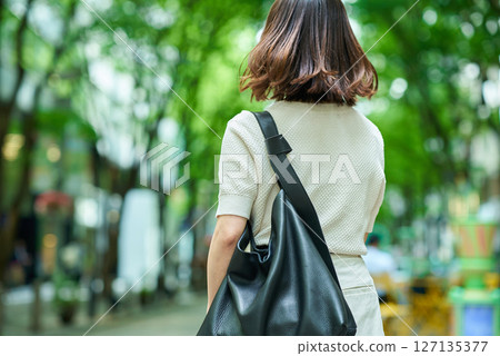 Woman looking back on the street 127135377