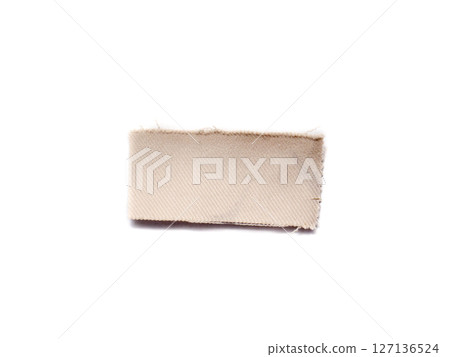 A piece of beige material isolated on a white background. 127136524