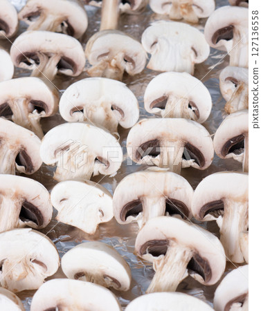 Champignons in a plastic container. Champignons in a plastic container. 127136558