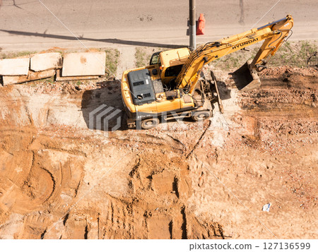 Hyundai excavator. The Architecture backgrounds and objects. Home construction. 127136599