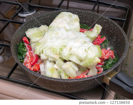 Frozen vegetables in a frying pan. 127136650