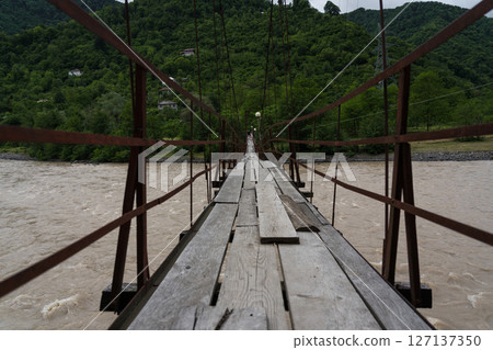 Wooden suspension bridge over the Cheryokha River, Georgia Wooden suspension bridge over the Cheryokha River, Georgia 127137350