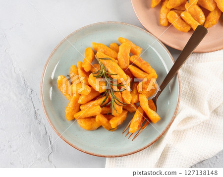 Pumpkin recipe homemade gnocchi on pastel color background Pumpkin recipe homemade gnocchi on pastel color background 127138148