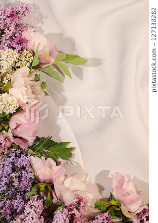 Beautiful spring blooming branches of lilac and mountain peony on sunny background. Abstract flower arrangement and banner for screen, Still life with place for text, Floral holiday card Beautiful spring blooming branches of lilac and mountain peony on sunny background. Abstract flower arrangement and banner for screen, Still life with place for text, Floral holiday card 127138282