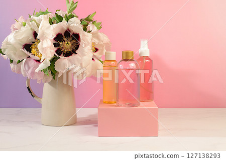 Spa salon advertising card, Wellness composition with rose water, fresh flowers of mountain peony and columbine, concept of natural self-care and healthy lifestyle, abstract composition with flowers. Spa salon advertising card, Wellness composition with rose water, fresh flowers of mountain peony and columbine, concept of natural self-care and healthy lifestyle, abstract composition with flowers. 127138293