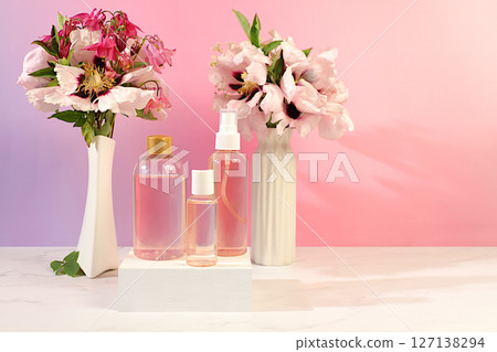 Wellness composition with rose water, fresh flowers of mountain peony and columbine, spa salon advertising card, natural self-care and healthy lifestyle concept, abstract composition with flowers. Wellness composition with rose water, fresh flowers of mountain peony and columbine, spa salon advertising card, natural self-care and healthy lifestyle concept, abstract composition with flowers. 127138294