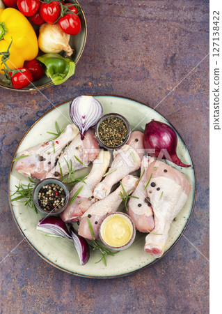 Uncooked raw chicken legs. 127138422