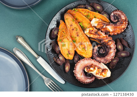 A dish with roasted octopus tentacles. 127138430