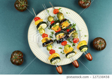 Grilled vegetable skewers on a plate. Grilled vegetable skewers on a plate. 127138438
