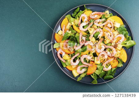 Healthy salad with shrimp prawns, persimmon and green salad. Healthy salad with shrimp prawns, persimmon and green salad. 127138439