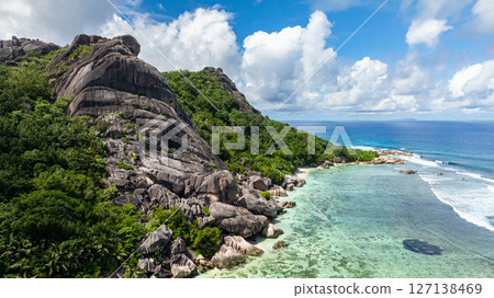 Tropical coastline with unique rock formations and shallow clear water. La Digue, Seychelles. 127138469