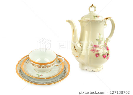 Elegant vintage porcelain coffee pot, porcelain cup and saucers isolated on white background. 127138702