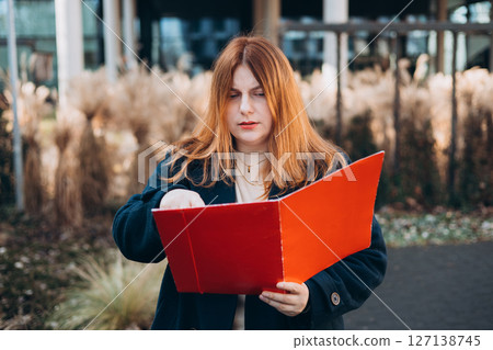 Businesswoman successful woman business person standing outdoor corporate building exterior. Elegance pretty caucasian professional 30s female Bank worker posing outdoors 127138745