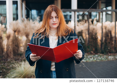 Businesswoman successful woman business person standing outdoor corporate building exterior. Elegance pretty caucasian professional 30s female Bank worker posing outdoors 127138746