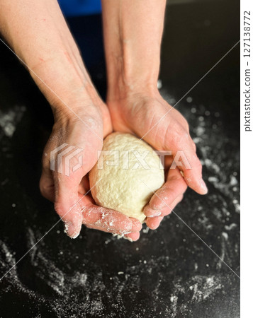 Homemade sourdough without yeast or gluten in woman hands. Ideal for allergy friendly diets, and natural food ads. 127138772