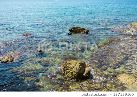 Blue sea and rocky coastline. Coastal nature and clear water landscape. 127139100