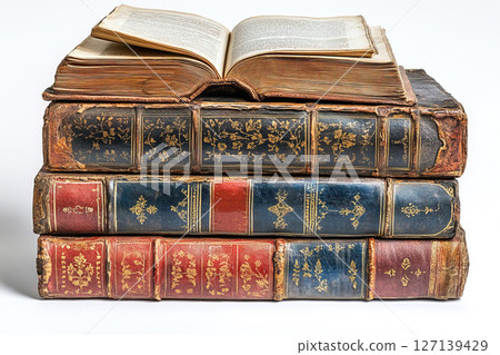 Stack of antique books with one open resting on top showcasing rich history and craftsmanship 127139429
