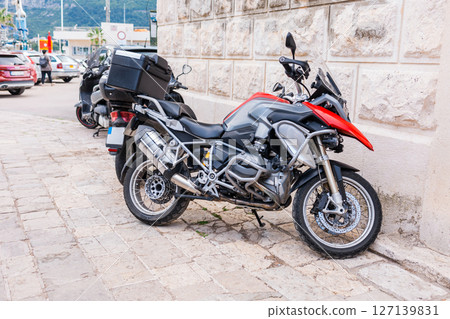 Modern touring motorcycle parked on a city street. Transportation, freedom, and adventure travel on two wheels. 127139831