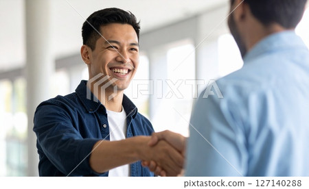 A smiling handshake of achievement A smiling handshake of achievement 127140288
