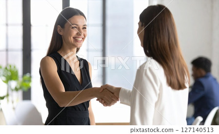 A smiling handshake of achievement 127140513