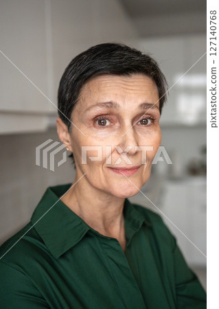Smiling confident mature woman with warm gaze. Aging process, emotional balance, self acceptance 127140768