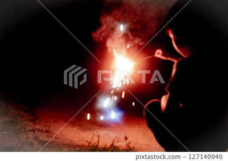 Hand-held fireworks that burn violently Hand-held fireworks that burn violently 127140940