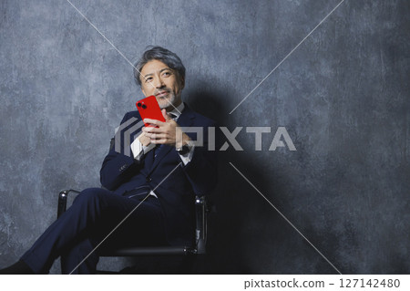 Senior businessman with a smartphone 127142480