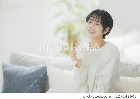 A woman drinking coffee A woman drinking coffee 127142605
