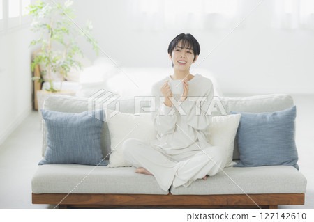 A woman drinking coffee 127142610