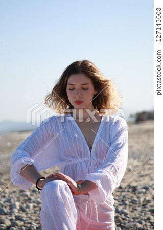 Oceanfront Leg Stretching by Blonde Beachgoer 127143008