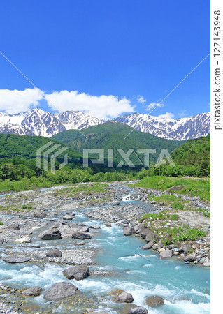 View of the Northern Alps in early summer from Hakuba Bridge 127143948