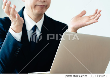 A businessman who is not good at using a computer A businessman who is not good at using a computer 127144042