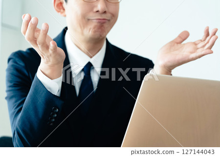 A businessman who is not good at using a computer A businessman who is not good at using a computer 127144043