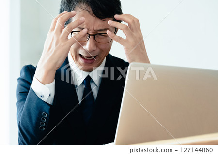 A businessman who is not good at using a computer 127144060