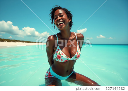 Joyful woman in a floral bikini at the beach. 127144282