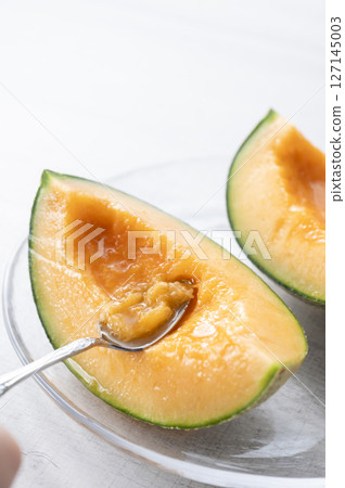 Eating a juicy melon Eating a juicy melon 127145003