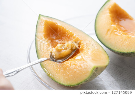 Eating a juicy melon Eating a juicy melon 127145099