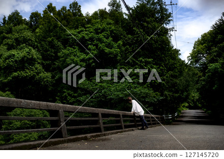 <Material> A woman walking along a mountain path in early summer with fresh greenery <Material> A woman walking along a mountain path in early summer with fresh greenery 127145720
