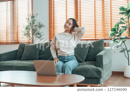 Young asian woman feeling pain in neck and shoulder 127146090
