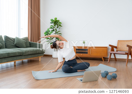 Young Asian woman stretching yoga workout on exercise mat Young Asian woman stretching yoga workout on exercise mat 127146093