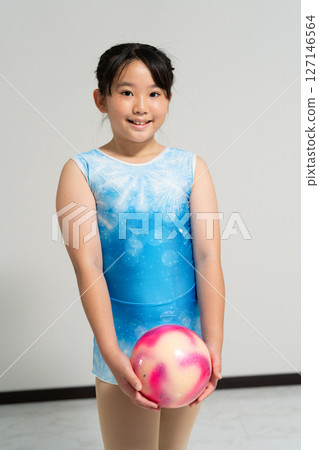 A lively girl trying gymnastics 127146564