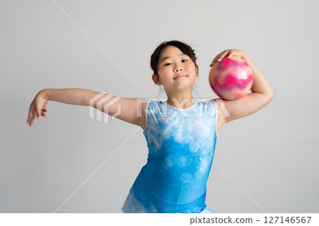 A lively girl trying gymnastics 127146567