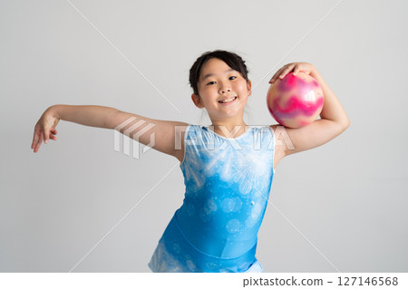 A lively girl trying gymnastics 127146568