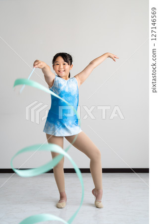 A lively girl trying gymnastics 127146569
